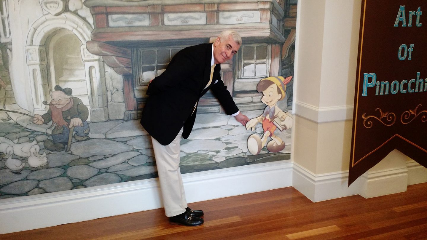 John Canemaker greets Pinocchio at the Walt Disney Family Museum.
