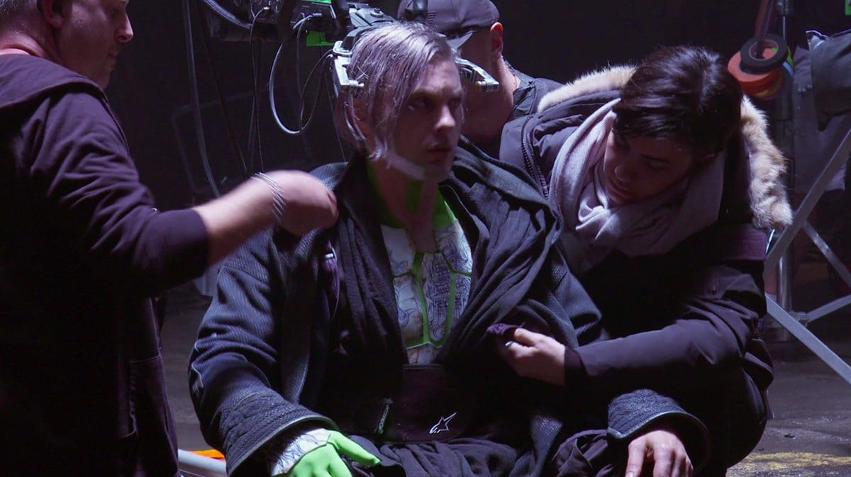 Michael Pitt on set in prosthetics and covered in greenscreen material pieces (screenshot from production b-roll).