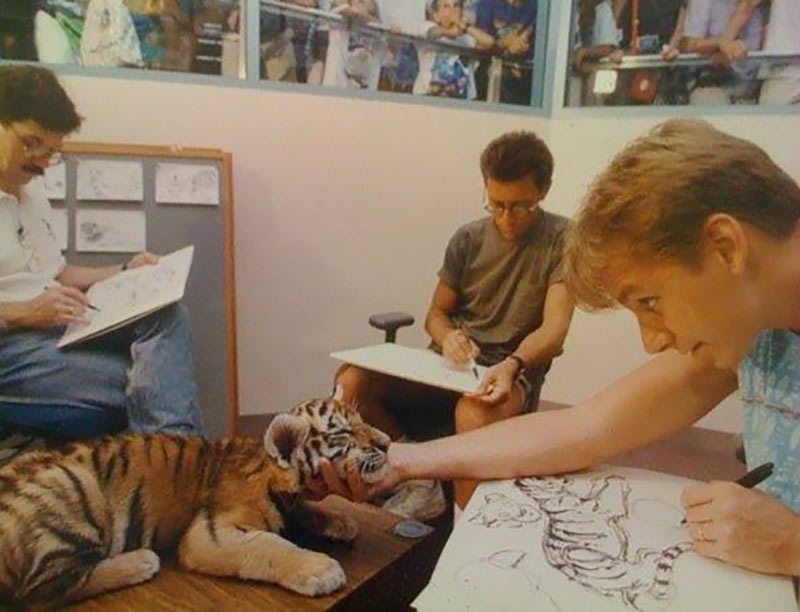 Aaron Blaise (right) drawing a tiger cub during the production of Disney's "Aladdin."