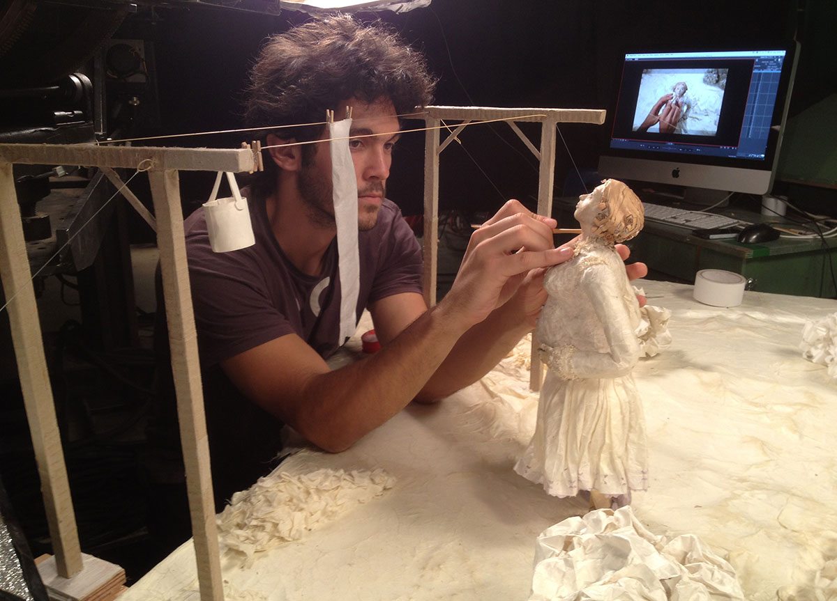 Animator working with a papier-mâché puppet from "Women's Letters."