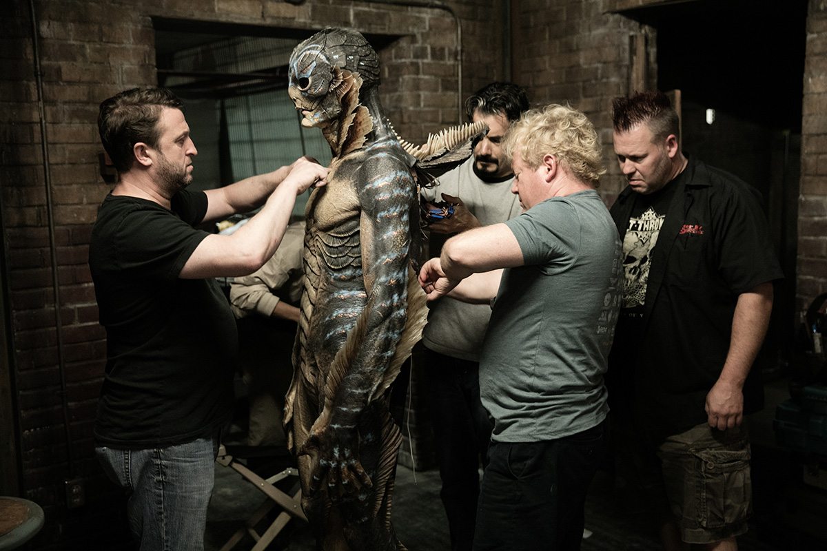 Shane Mahan (second from right) and other Legacy Effects crew members work on the prosthetics worn by Doug Jones on the set of "The Shape of Water."