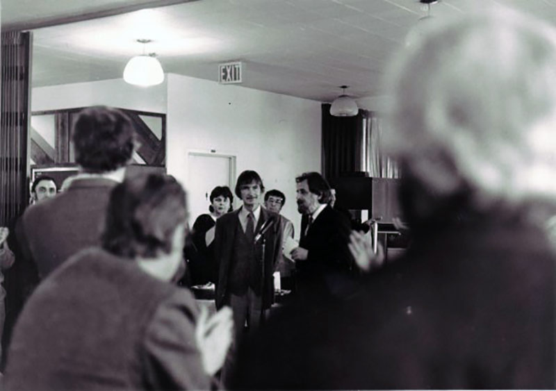 Norman McLaren's retirement party in 1983 in the NFB cafeteria. Hélène Tanguay is standing left of McLaren.