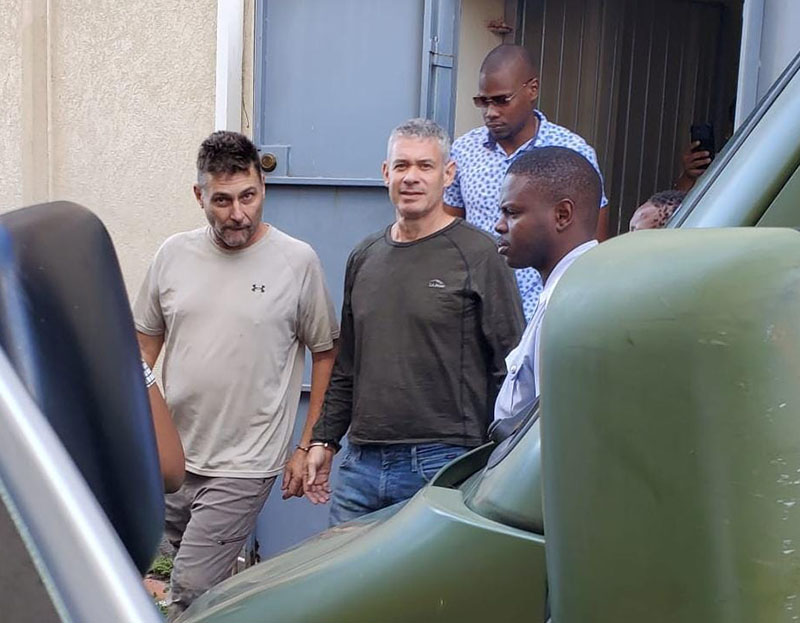 Jonathan Lehrer (right) and Robert Snider being taken to jail after being charged with murder